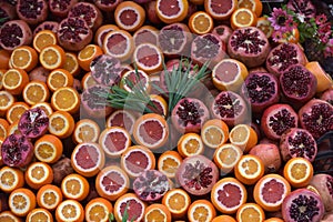 Oranges and pomegranates are sliced for juice