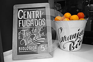 Oranges for sale in the window of a shop in Seville, monochrome colour key photo