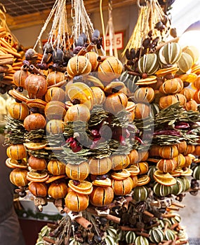 Oranges and spices christmas hanging ornaments, advent market stall close up, photo