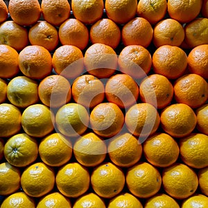 Oranges stacked on market stall, vibrant citrus fruit display photo