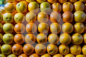 Oranges stacked on market stall, vibrant citrus fruit display photo