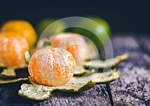 Oranges on wooden table with black shadow