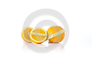 Oranges wrapped with a white tape measure. Healthy, organic food and diet concept.