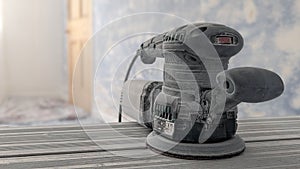 An orbital sander hook and loop 12 inch sanding disc attached in sitting room