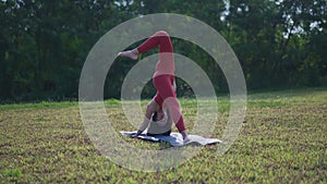 Orbiting slow motion Asian chinese female yoga yogi stretching in morning sun singapore