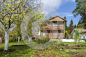 Orchard in front of a country house, in autumn