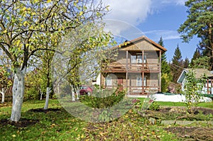 Orchard in front of a country house, in autumn