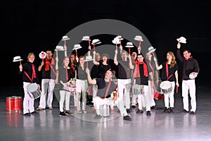 Orchestra drummers in costumes with hats raised on