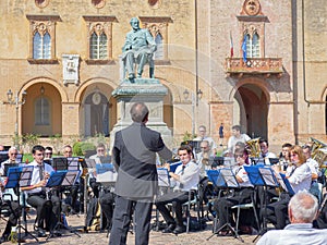 Orchestra Performing Outdoors right in Front of Rocca Pallavicino and the Statue of Giuseppe Verdi, Italian Composer, Parma, Italy