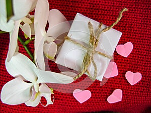 Orchid and hearts on red cloth, Valentines Day background, wedding day