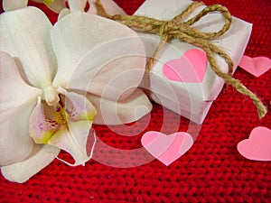 Orchid and hearts on red cloth, Valentines Day background, wedding day.