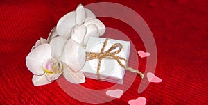 Orchid and hearts on red cloth, Valentines Day background, wedding day.