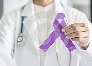 Orchid purple lavender ribbon awareness in doctorÃ¢â¬â¢s hand for (all kinds cancers), Testicular Cancer awareness photo