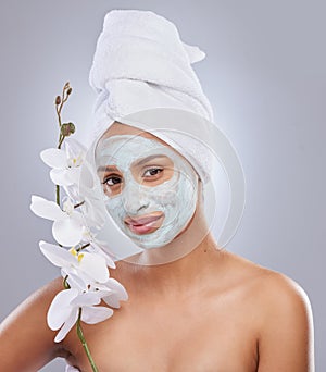 Orchid, woman and face mask for skincare, cosmetic and facial treatment on white background. Beauty, natural or portrait