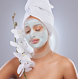 Orchid, woman and face mask for skincare, cosmetic and facial treatment on white background. Beauty, natural or portrait