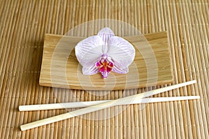 Orchids on bamboo mat abstract asian food unique concept