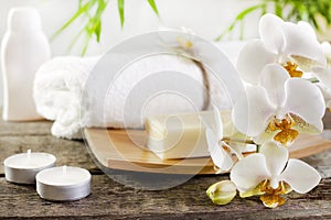 Orchids and towel on wooden boards