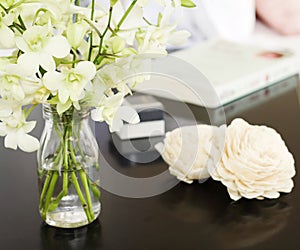 Orchids in vase on pretty bedside table square