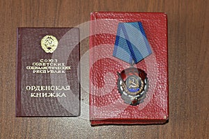 Order of Soviet times Red Banner and document on it.