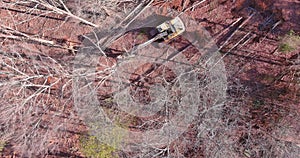 In order to prepare the land for construction, a tractor is used to uproot trees