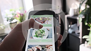 Ordering food from restaurant online using smartphone app close up.