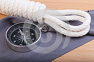 Orderliness white scout rope, compass and fabric. photo