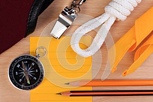 Orderliness white scout rope, scarf, whistle, compass, pencil and paper note.