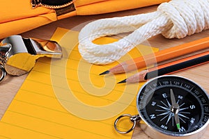 Orderliness white scout rope, scarf, whistle, compass, pencil and paper note. photo