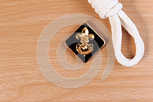 Orderliness white scout rope with vintage boy scouts badge on wooden table. photo
