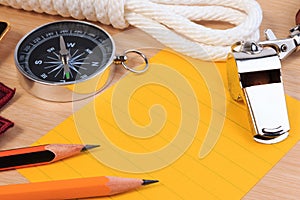 Orderliness white scout rope, whistle, compass, pencil and paper note. photo