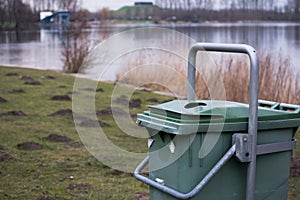 Green Garbage Bin Trash in the Forest Grass Water Nature Object photo