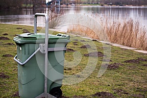 Green Garbage Bin Trash in the Forest Grass Water Nature Object photo