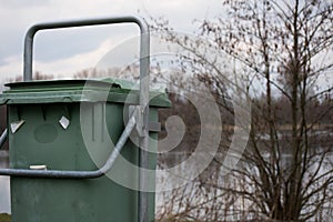Green Garbage Bin Trash in the Forest Grass Water Nature Object photo