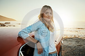 The ordinary bores me. Portrait of a young woman enjoying a road trip along the coast.