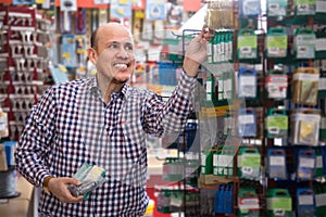 Ordinary elderly man choosing nails