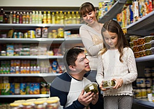 Ordinary family of three purchasing canned food