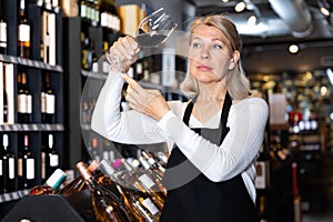 Ordinary female winemaker holding glass of wine