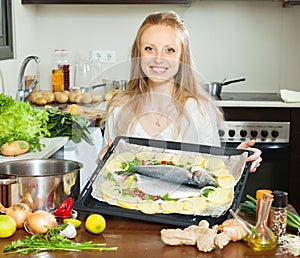 Ordinary housewife cooking fish in sheet pan photo