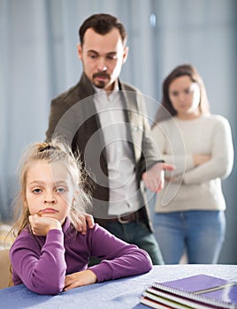 Ordinary parents lecturing girl for bad behavior