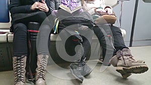 Ordinary people in subway, commuters sitting in metro train
