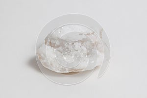 Ore milky quartz on white background.