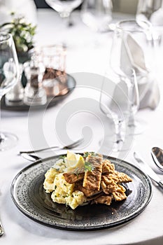 Orecchio d'elefante, Italian schnitzel, served cut in strips with potato salad photo
