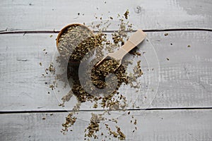 Oregano: dried, dehydrated on an old wooden table. Top view.