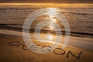 Oregon Coast sunset, text written on the beach