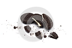 Oreo Biscuits with broken and  crumbs isloated on white background. It is a sandwich chocolate cookies with a sweet cream.