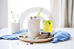 oreo milkshake with cookie crumbles, whole oreos on plate