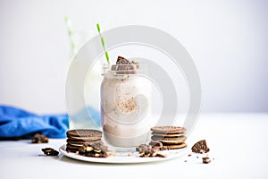 oreo milkshake with cookie crumbles, whole oreos on plate