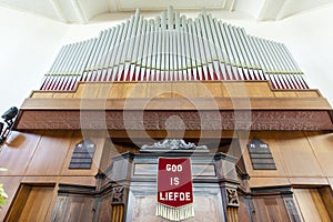Organ with banner God is lOve God is liefde of the Dutch Reformed church in Swellendam, Western Cape, South Africa