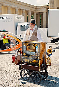 Organ grinder, man, with musical box in city