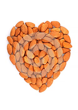Organic Almond nuts forming a heart-shape isolated on white background